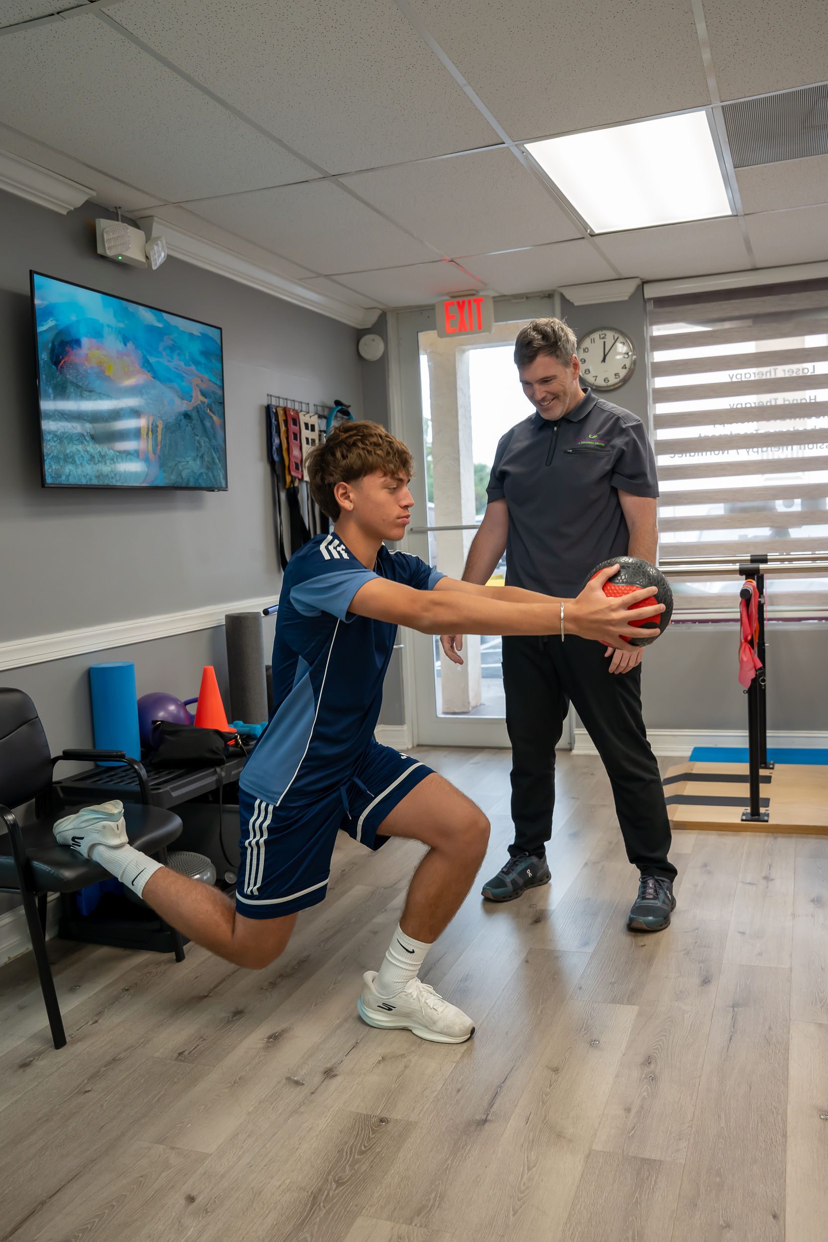 Young athlete doing functional strength training with medicine ball at Esencia